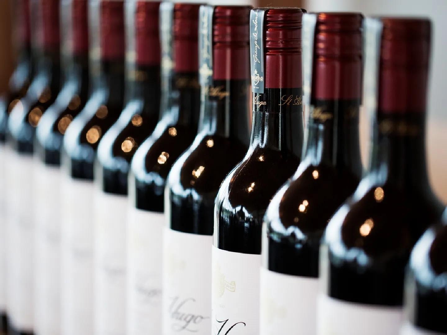 Close up of multiple St Hugo bottles of red wine presented in a line.