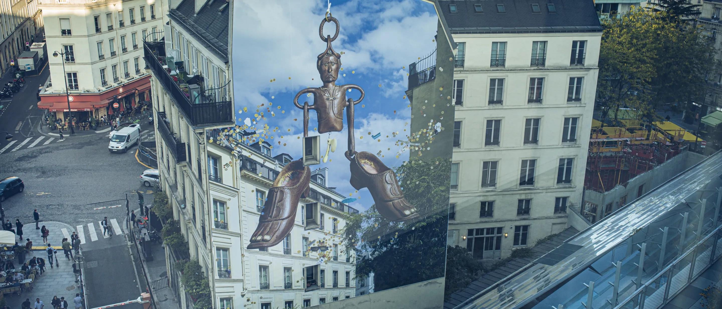 Mural on side of building with Parisian buildings surrounding