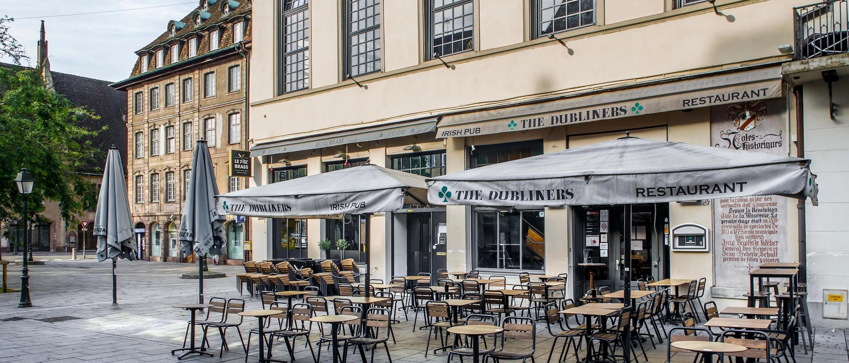 Large building with outdoor terrasse and awning